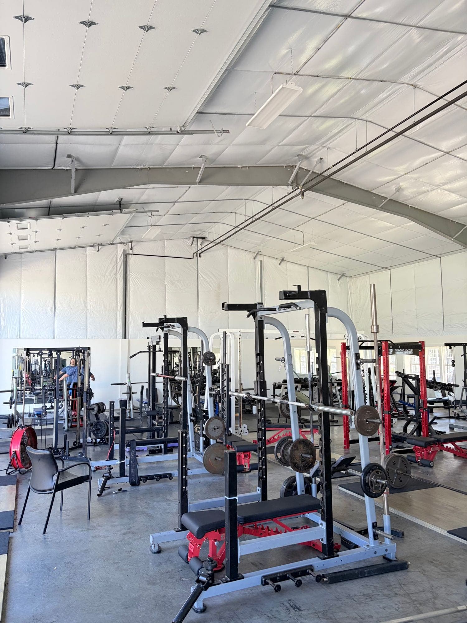 Squat racks, Smith machines and loaded barbells on the free weight floor at Hanley's Gym